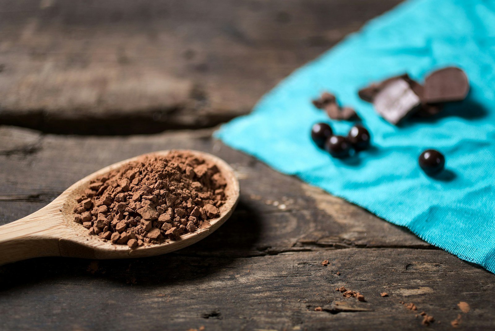 Wooden spoon of cocoa powder used as a food ingredient